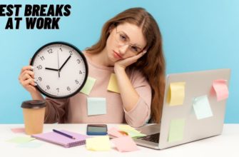 A female employee feeling tired is sisitting in the office holding a clock waiting for Rest Breaks at Work