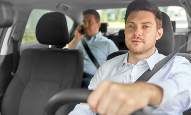 A driver driving car while boss is sitting in the back seat. Rest Breaks at Work: Step-by-Step Guide for Employers